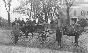 Dr. Dewitt Wilcox is standing adjacent to the wagon in 1902. Hennepin Hall on the northwest side of Center and 7th Streets has been a home, a restaurant, a school, and presently the rectory for St. Peter's Catholic Church.